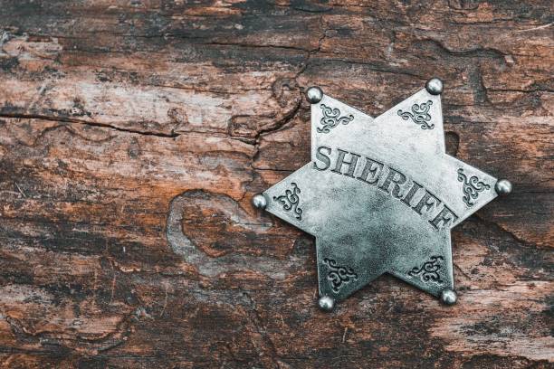 istock Sheriff badge on wooden background. 665120526