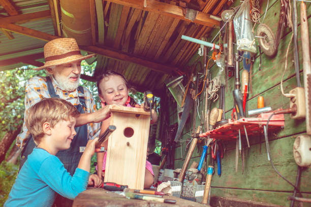 istock Grandpa with children make birdhouse 665121330