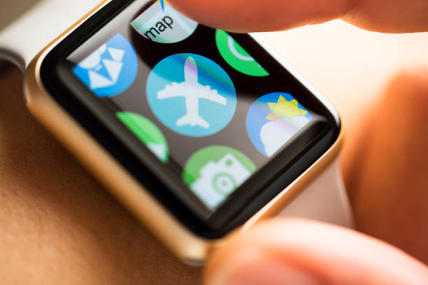 istock Finger touching app with plane icon on smart watch screen 665128312