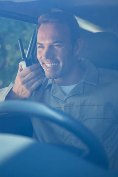 istock Delivery driver talking on walkie-talkie 665130992