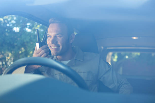 istock Delivery driver talking on walkie-talkie 665131032