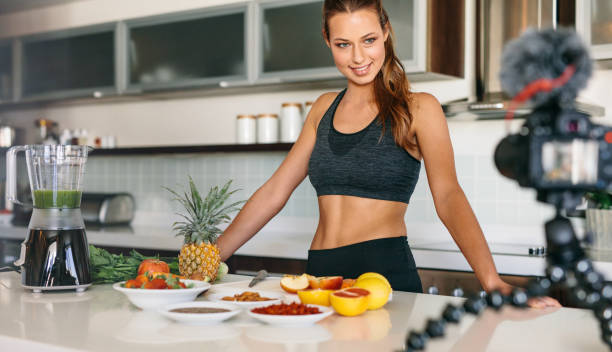 istock Young woman recording content for her blog in kitchen. 665136480
