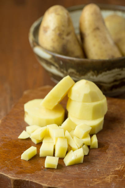 istock Potatoes and potato sliced on wooden table. Selective focus 665142774