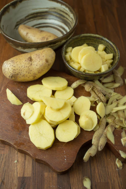 istock Potatoes and potato sliced on wooden table. Selective focus 665142784