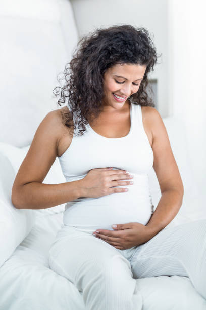istock Pregnant woman touching tummy 665146376