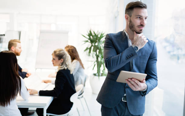istock Businessman working and holding tablet in modern office 665150942