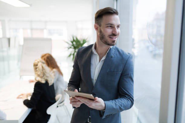 istock Businessman working and holding tablet in modern office 665150944