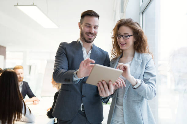 istock Smiling happy colleagues working at company office 665150948