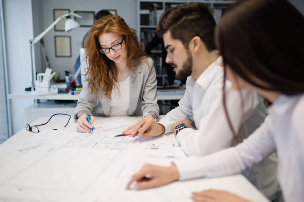 istock Business people and architects collaborating on business project 665153688