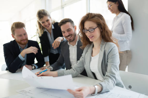 istock Group of business people collaborating on project  in office 665154132