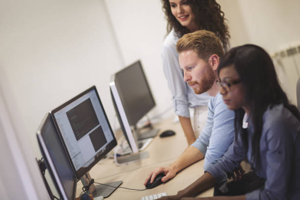 istock Programmers and business people collaborating in company office 665154882