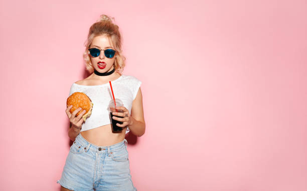 istock Pretty seductive female with fast food 665165860