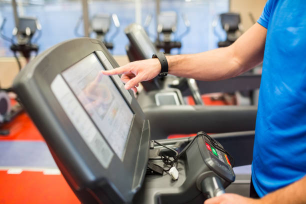 istock Man adjusting the settings of a treadmill 665167504