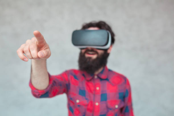 istock Amazed man touching air wearing VR goggles 665170434