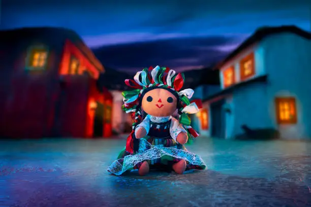 Photo of Mexican rag doll in a traditional dress at night