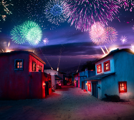scale model of a mexican town at twlight with fireworks