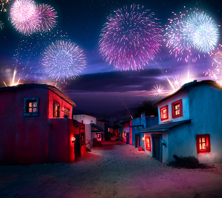 scale model of a mexican town at twlight with fireworks