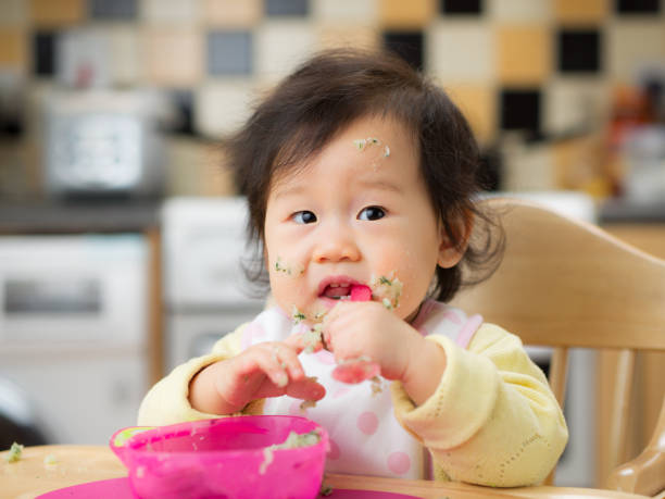 istock eating mess baby girl 665209332
