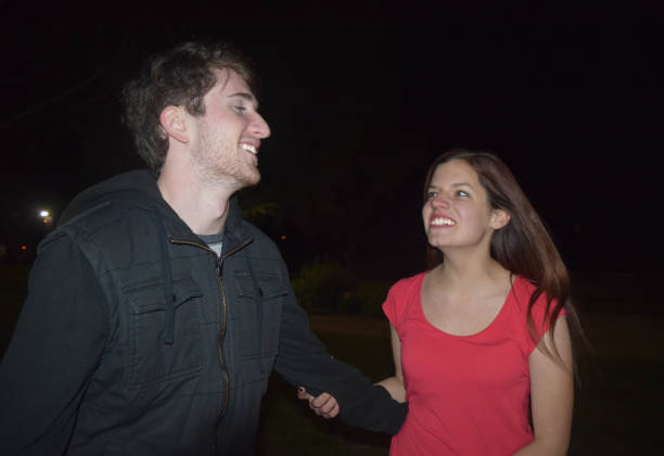 istock Teenage Couple Smiling at Night 665209406