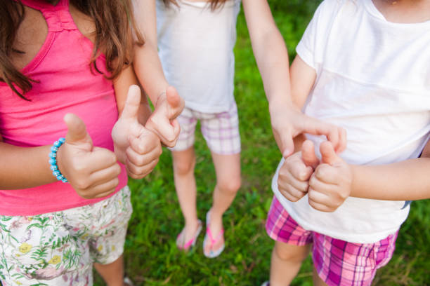 istock Thumbs up - Unrecognizable Girls 665209434