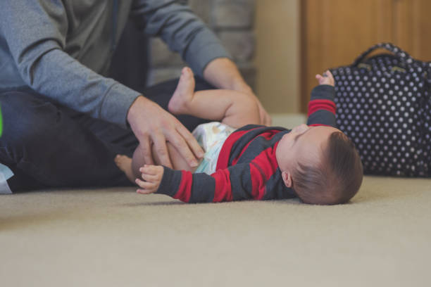 istock Young father sitting with infant son on the floor 665212538