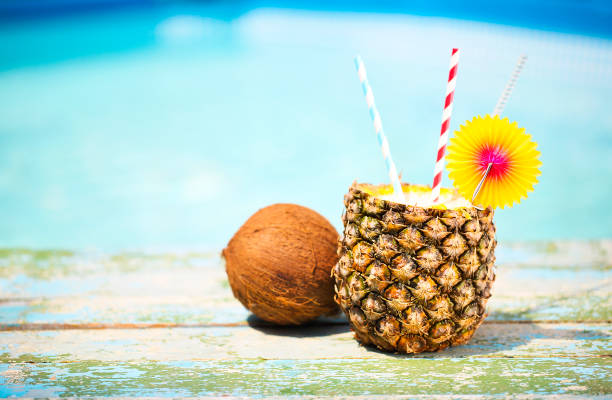 Exotic pineapple cocktail near pool. Pina colada