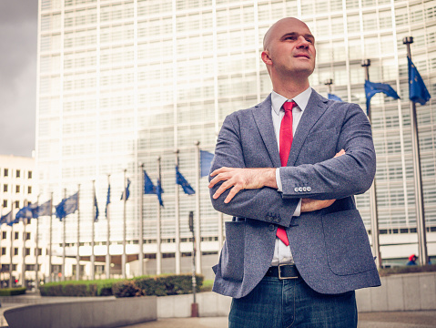 Businessman or politician dealing with daily business matters in Brussels, capital city of EU. Businessman using communication skills to achieve ambitious plans in Brussels regarding the Brexit and other relevant policies in EU.