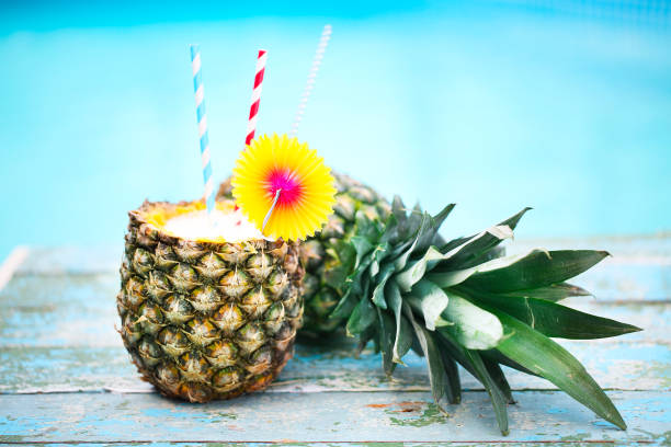 istock Exotic pineapple cocktail near pool. Pina colada 665212766
