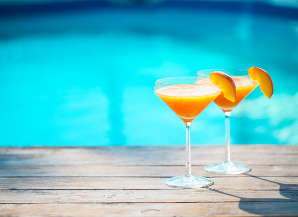 istock Champagne glasses with peach Bellini cocktail 665215808