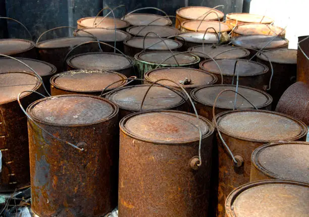 A group of old rusted paint cans.