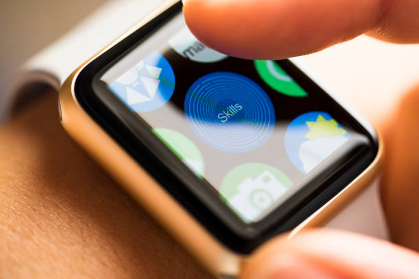 istock Finger touching skills app icon on smart watch screen 665218966