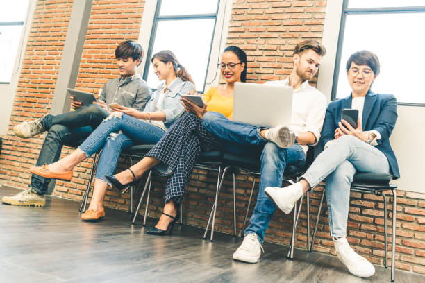 istock Multiethnic diverse group of young and adult people using smartphone, laptop computer, digital tablet together. Modern lifestyle with infomation technology gadget, education, social network concept 665222838