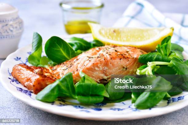 Grilled Organic Salmon With Salad Leaves On A Vintage Plate Stock Photo - Download Image Now