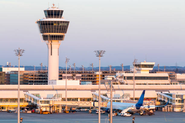 Air Traffic Control Tower in Munich Airport, Germany Franz-Josef-Strauss Munich airport with control tower, passenger airplane standing at the gates, apron area, long exposure with tripod. munich airport stock pictures, royalty-free photos & images