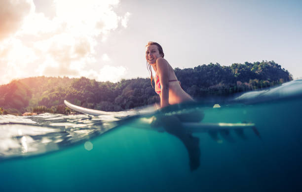 istock Young woman with surfboard 665231480