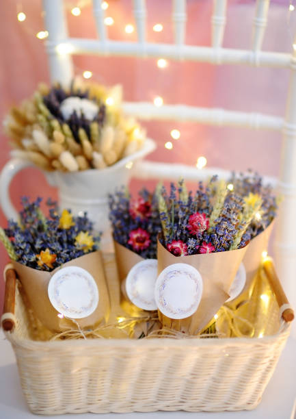 istock Beautiful dried flowers in paper boxes with lights on background 665235040