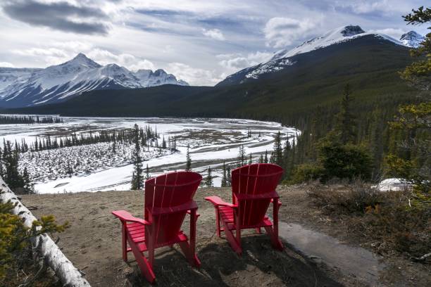istock Red Adirondack Chairs Howse River Rocky Mountains Panorama 665238716
