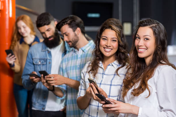 istock Happy male and female executive using mobile phone in office 665248858