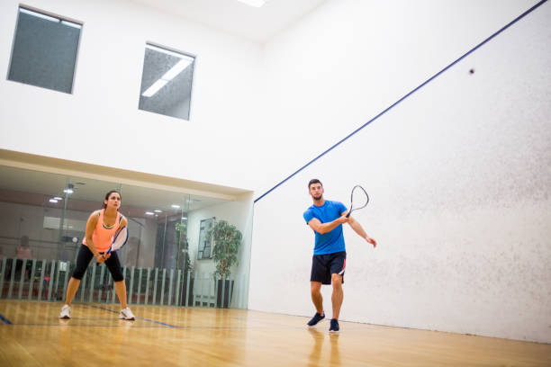 istock Couple playing a game of squash 665249894