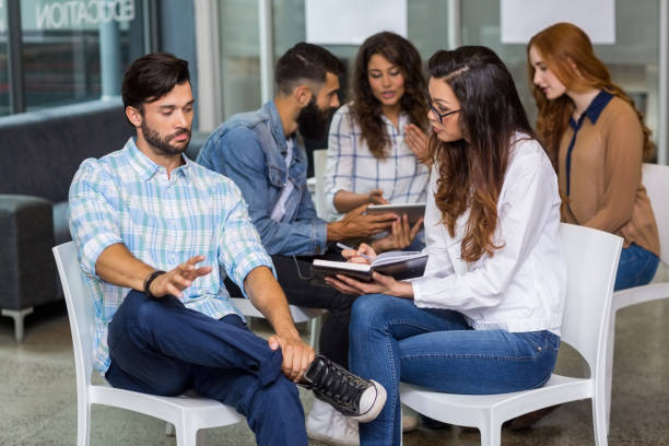 istock Male and female executives interacting with each other during meeting 665252004