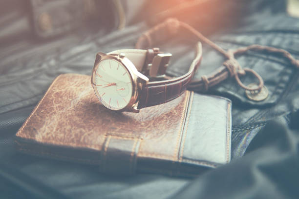 istock watches, wallet and phone on leather 665252414