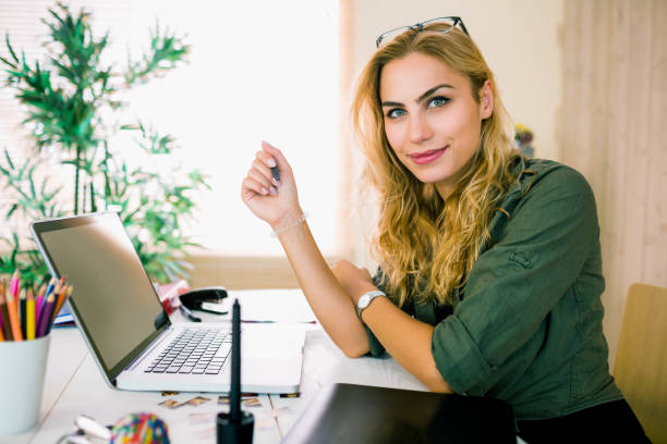istock Pretty blonde working at desk 665257144