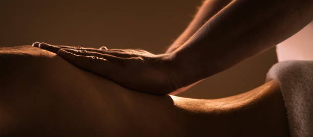 Massage closeup with hands of professional masseur stock photo