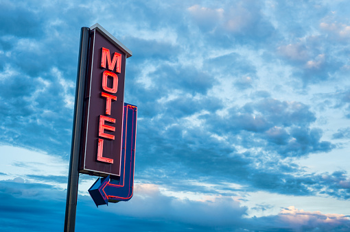 El Motel rojo neón signo sobre un cielo nublado del atardecer photo