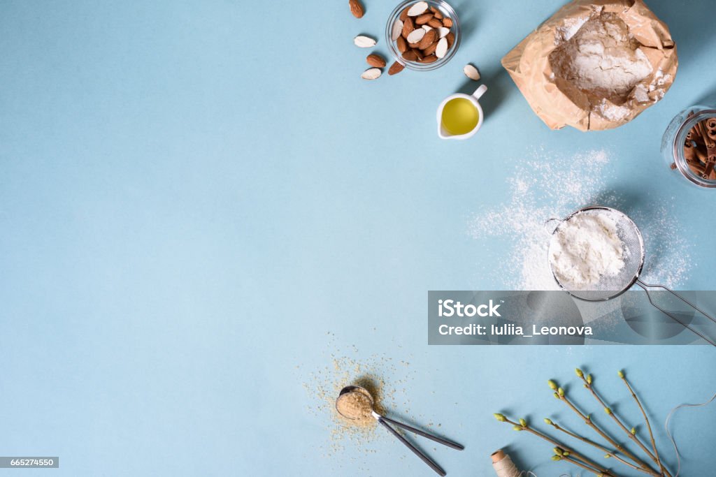 Baking ingredients for pastry on the blue background. Cooking cakes or bread. Baking ingredients for pastry on the blue background. Cooking cakes or bread concept. Top view, copy space. Bread Stock Photo