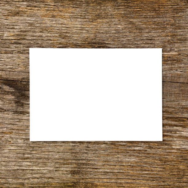 White paper card on old wooden desk.