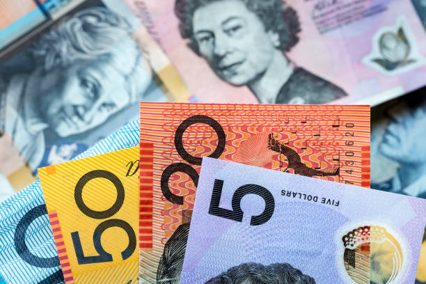 Australian Money Background Australian money background.  Focus on foreground, blurred faces beneath. five dollar bill stock pictures, royalty-free photos & images