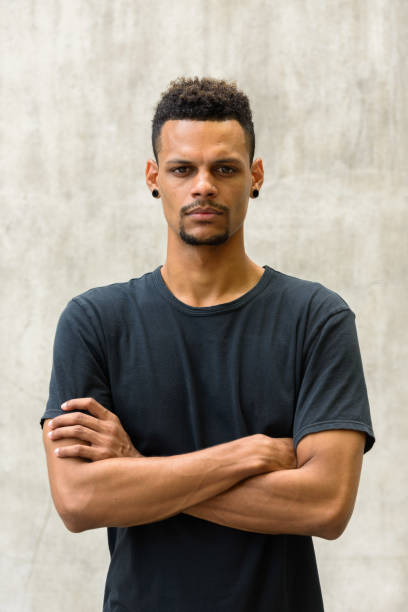 istock Young handsome African man with arms crossed 665280476