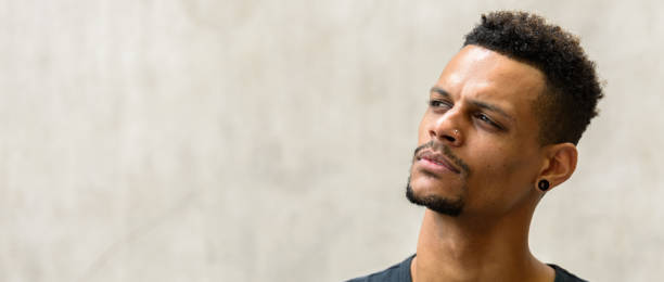 istock Face of young handsome African man thinking against concrete wall 665280506