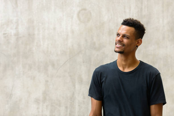 istock Young happy African man smiling while thinking and looking up 665280526